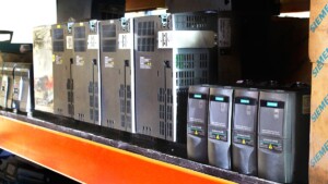 Row of Siemens drives and automation components on warehouse shelf