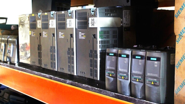 Row of Siemens drives and automation components on warehouse shelf